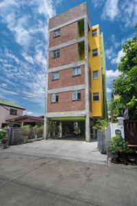 a tall brick building with a yellow at ST88 Residence in Nonthaburi