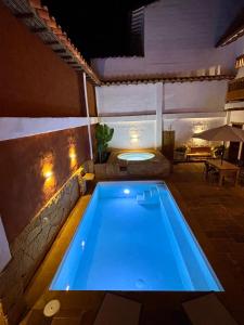 a swimming pool in the middle of a house at night at Casa Mónica Barichara in Barichara