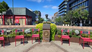 a group of pink chairs in front of a fountain at Courtyard by Marriott San Diego Downtown Little Italy in San Diego