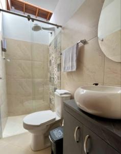 a bathroom with a sink and a toilet and a shower at Fami Hotel Luz de Luna in Jardin