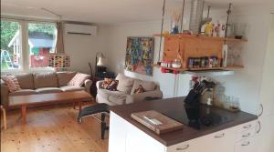 a living room with a couch and a table at Spersboda 2 barnvänliga hus sjöutsikt & VARM pool Spersboda in Spersboda