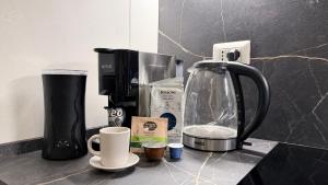 a counter top with a coffee maker and affeepot at Pomodoro House - Luminoso appartamento vicino Linate, Duomo, Fabrique, Unipol Dome in Milan