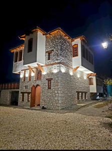 a large stone building at night with a street light at Macedonium Luxury Villa with big pool & Fireplace in Skopje