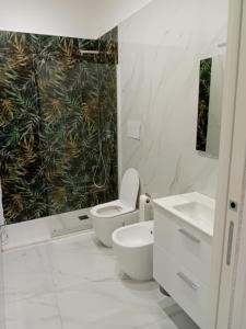 Il Don Giovanni Room في بارليتا: حمام أبيض مع مرحاض ومغسلة