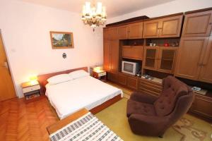 a bedroom with a bed and a chair at House Paulina in Banjole