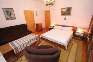 a living room with a bed and a couch at House Paulina in Banjole