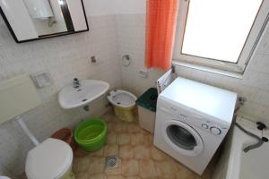 a small bathroom with a washing machine and a sink at House Paulina in Banjole +24 photos