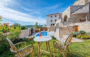 a table and chairs in the yard of a house at Villa Beram in Pazin