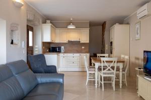 a living room with a couch and a table and a kitchen at Villa Beram in Pazin