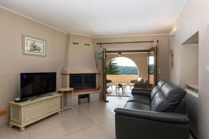 a living room with a couch and a flat screen tv at Villa Beram in Pazin