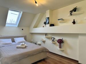 a bedroom with a bed with a stuffed animal on it at Gusterita Hideaway in Sibiu