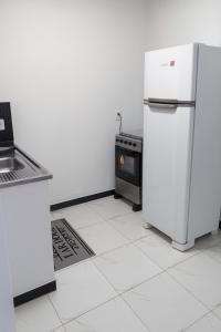 a kitchen with two refrigerators and a stove at Residencial céu aberto in Porto Seguro +3 photos