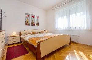 a bedroom with a bed and a large window at Villa Cera in Vodnjan +27 photos