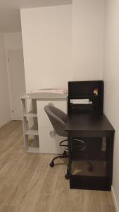 an office with a desk with a computer and a chair at T3 lumineux avec balcon, proche des transports in La Celle-sous-Gouzon +5 photos