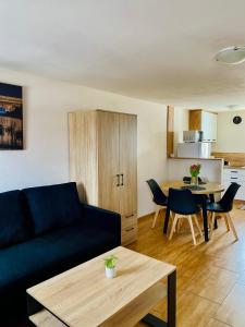 a living room with a couch and a table at Solina domki-„Solińskie wzgórze” in Solina