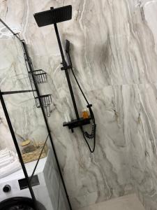 una doccia in un bagno con un muro in pietra di Harmony Suite a Baia Mare Altre 25 foto