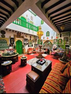 a living room filled with furniture and a green door at riad cherif in Marrakech