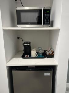 Turks and Caicos Airport Hotel في بروفيدنسياليس: وجود فرن مايكرويف فوق الثلاجه +9 صور