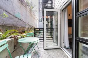 a small balcony with a table and a glass door at Downtown Edge-Stylish Studio Near Hospitals & Downtown-03 in Seattle