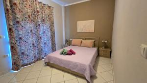 a bedroom with a bed with two stuffed animals on it at Vasilikis Place in Elafonisos