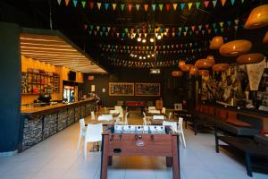 a restaurant with a table and chairs and a bar at The Hostel Santiago in Santiago