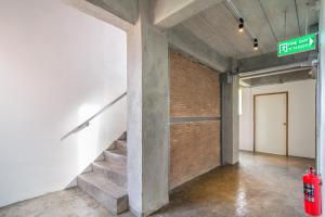 a room with a staircase and a brick wall at ST88 Residence in Nonthaburi