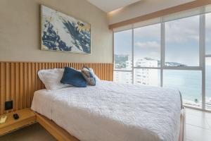 a bedroom with a bed with a view of the ocean at Amazing Condo Ocean View By Bamboo Skylife in Acapulco +28 photos