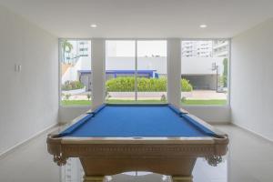 a pool table in a room with a window at Amazing Condo Ocean View By Bamboo Skylife in Acapulco