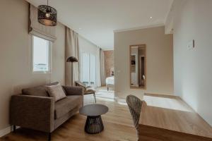 a living room with a couch and a table at Hotel Reva TAHITI in Papeete