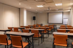 an empty classroom with tables and chairs and a whiteboard at Novotel RJ Praia de Botafogo in Rio de Janeiro +141 photos