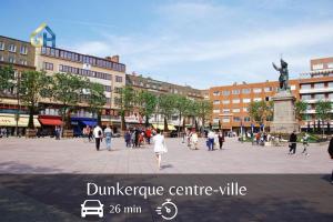 a group of people walking in a city square at La Pause - Centre-ville in Bourbourg