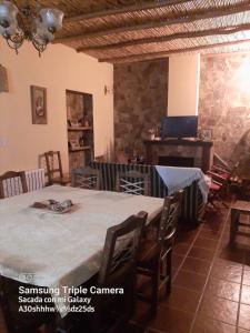 a room with a table and chairs and a fireplace at Ñawpa Wasi in Humahuaca +13 photos