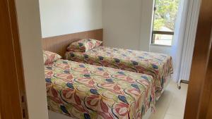 a bed and a couch in a room at Bioflora 69 Itacimirim in Camacari