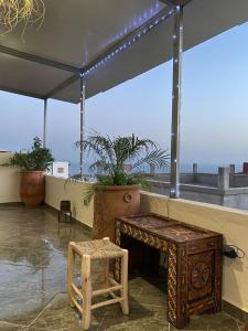 een bank en een kruk in een kamer met uitzicht bij Breeze surf lodge in Tamraght Ouzdar