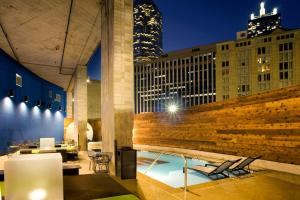 a lobby with a table and chairs and buildings at Aloft by Marriott Dallas Downtown in Dallas