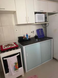 a small kitchen with a sink and a microwave at Cintia Luiza in Aracaju