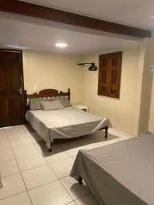 a bedroom with two beds in a room at Solar do Sal in Salinópolis +47 photos