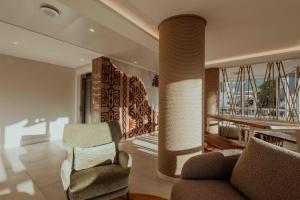 una sala de estar con un sofá y una silla en Hotel Reva TAHITI, en Papeete