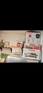 a refrigerator filled with boxes of food on a shelf at Agréable petite maison rustique in Saint-Geniès-de-Varensal +69 photos