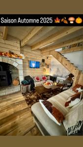 a room with a living room with a fireplace at Agréable petite maison rustique in Saint-Geniès-de-Varensal