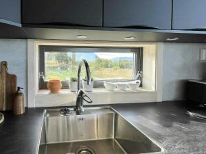 a kitchen with a sink and a window at Newly Built Cabin On Andøya With Northern Lights in Bø Andøya