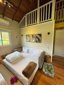 a bedroom with a large white bed in a room at Condado de Urubici - Cabana in Urubici