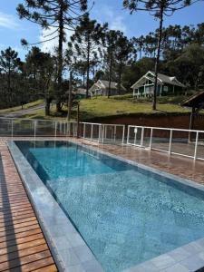 a swimming pool with blue water in a house at Condado de Urubici - Cabana in Urubici