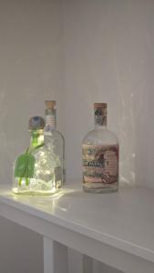 two bottles of alcohol sitting on a shelf at Dimora Storica Gold Room in Ruviano