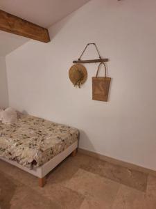 a bedroom with a bed and a basket on the wall at Maison type T3 à Ventabren in Ventabren