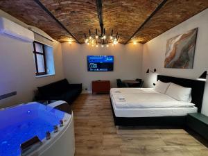 a room with a bed and a bath tub at Rybaki Sauna & Jacuzzi Apartment in Poznań +5 photos