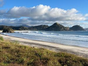 a beach with mountains in the background and the ocean at Medlands Retreat with Breathtaking Views in Medlands