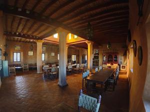 a large room with a wooden table and chairs at Auberge Merzane in Merzane