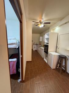 a room with a kitchen with a ceiling fan at La terraza del Portal in Arequipa