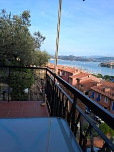 a balcony with a view of the water at Desiree Holiday Inn in Le Grazie